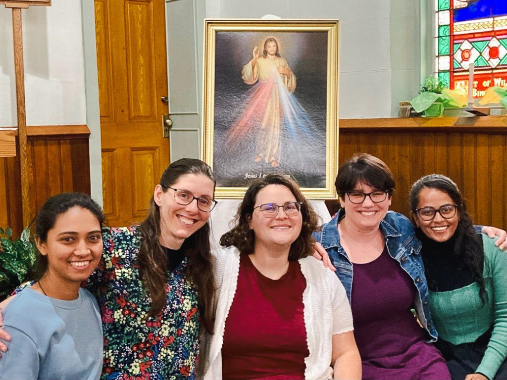 group in front of Divine Mercy image